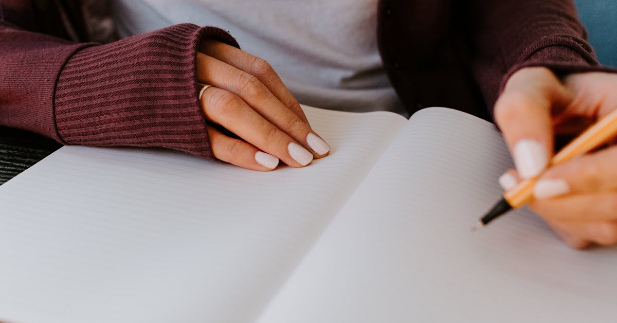 Woman writing in notebook